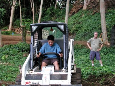 Brian on the bobcat helping clear the yard