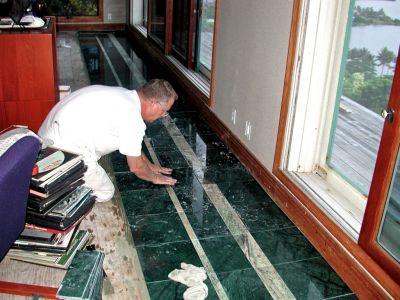 Tim finishing the edge tile on the second floor in the living room