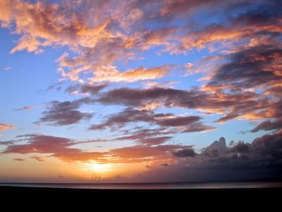 a sunset on the north shore.  we went up there because there was a solar eclipse that day, but time zone made this at the wrong time, but it was an great sunset anyways